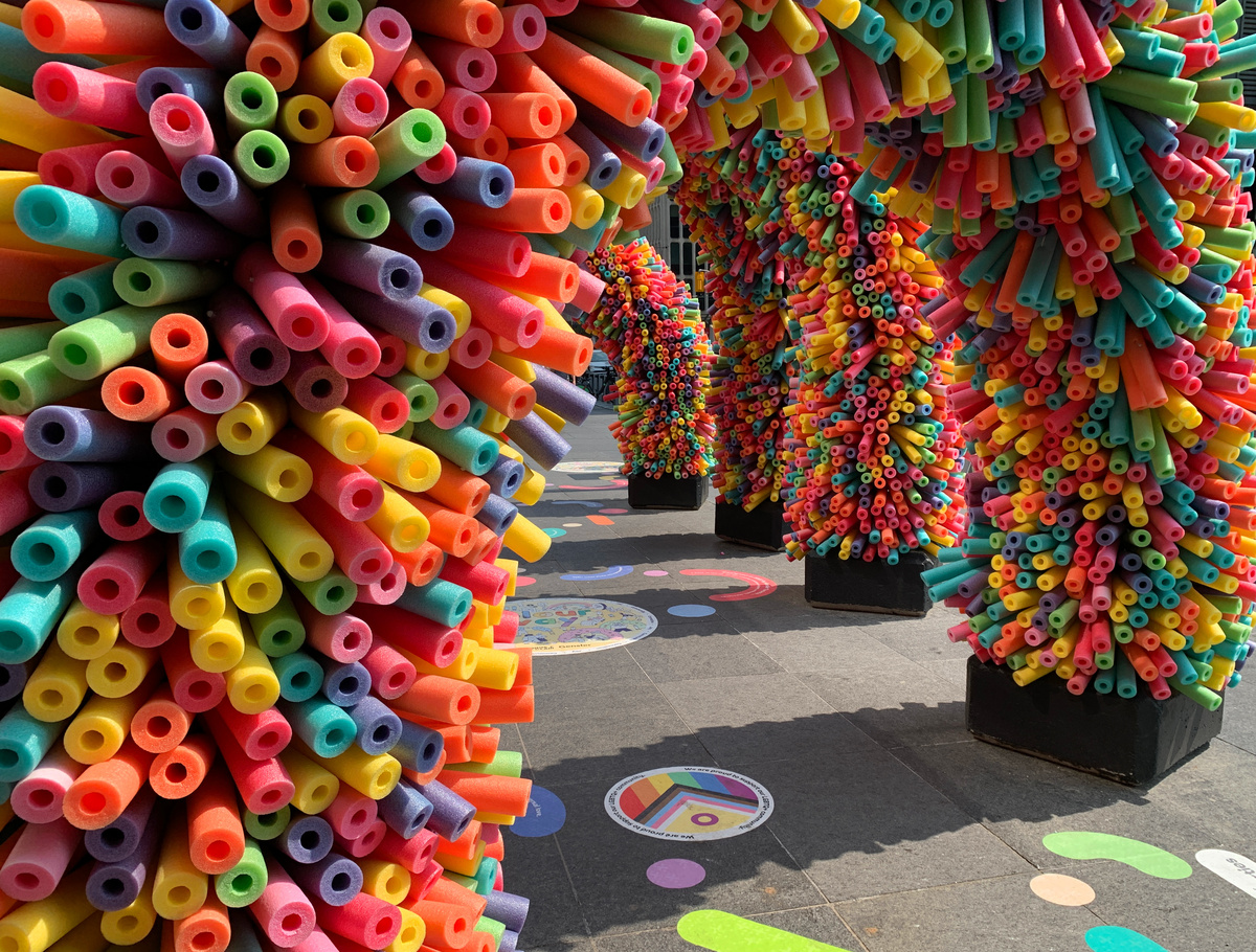several arches constructed of multi-coloured pool noodles.